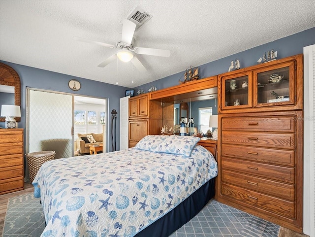 bedroom with a textured ceiling and visible vents