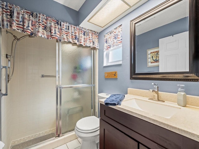 full bath with a stall shower, tile patterned flooring, vanity, and toilet