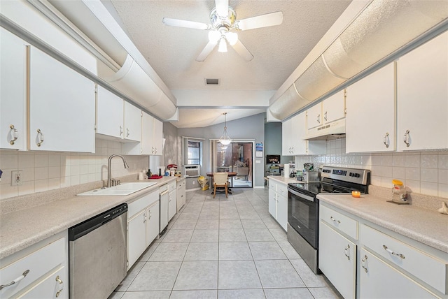 kitchen with stainless steel appliances, decorative light fixtures, white cabinetry, and under cabinet range hood