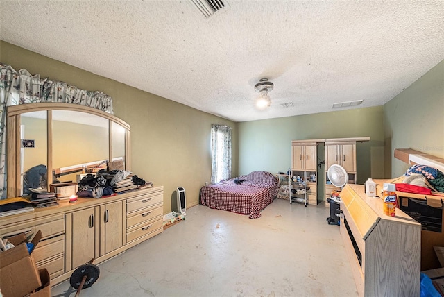 bedroom featuring ceiling fan, a textured ceiling, visible vents, and concrete flooring