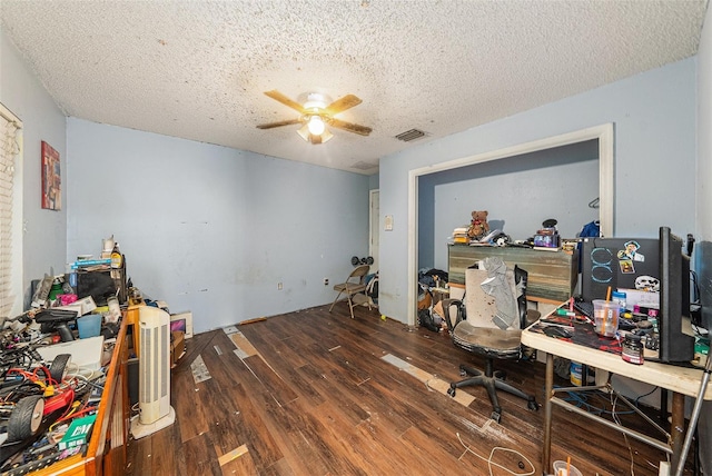 office with visible vents, a textured ceiling, a ceiling fan, and dark wood-style flooring