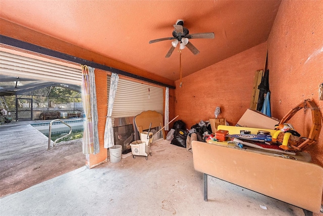 interior space with lofted ceiling and ceiling fan