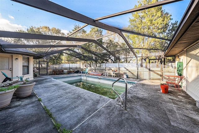 view of swimming pool with a patio, glass enclosure, a fenced backyard, and a fenced in pool