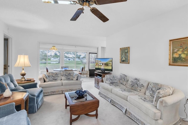 living room with a ceiling fan and carpet