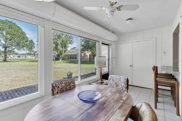 dining room with ceiling fan and light tile patterned flooring