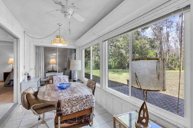 sunroom featuring a ceiling fan