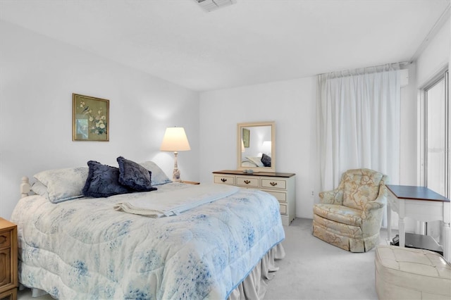 bedroom with light colored carpet and visible vents