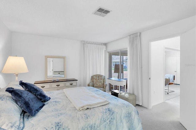 bedroom with visible vents and light carpet