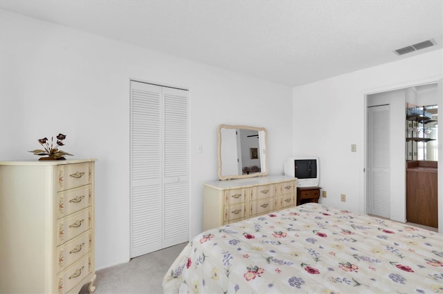 bedroom with light carpet, a closet, and visible vents