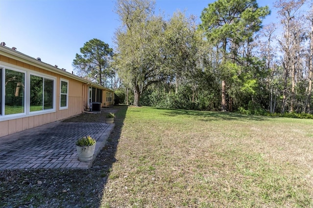 view of yard with a patio area and central AC unit