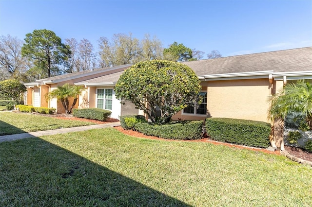 view of front of property featuring a front yard and stucco siding