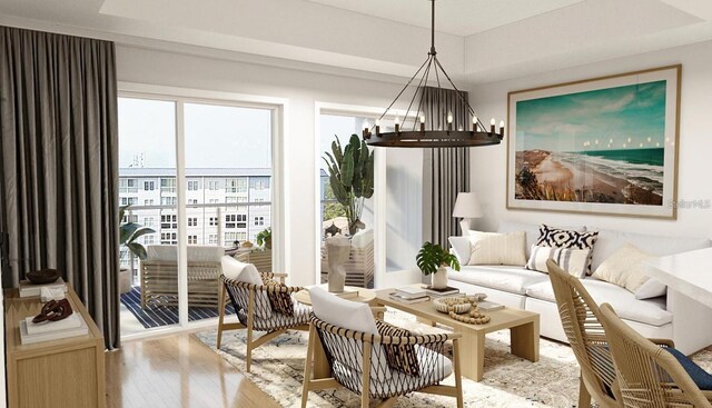 interior space with light wood-type flooring, a tray ceiling, and a notable chandelier