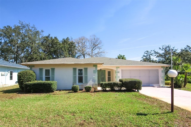 single story home with driveway, a garage, a front lawn, and stucco siding