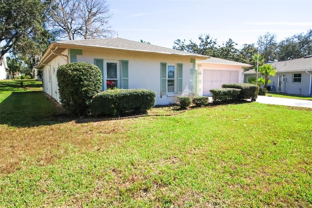 ranch-style home with a garage, a front yard, concrete driveway, and stucco siding