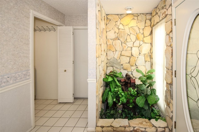 interior space featuring tile patterned flooring and a textured ceiling