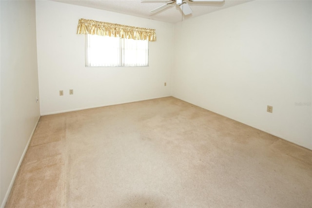 unfurnished room featuring light carpet and ceiling fan