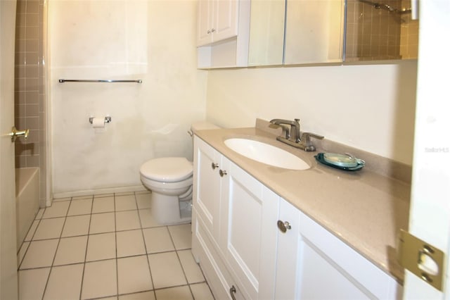 bathroom with shower / tub combination, toilet, vanity, baseboards, and tile patterned floors