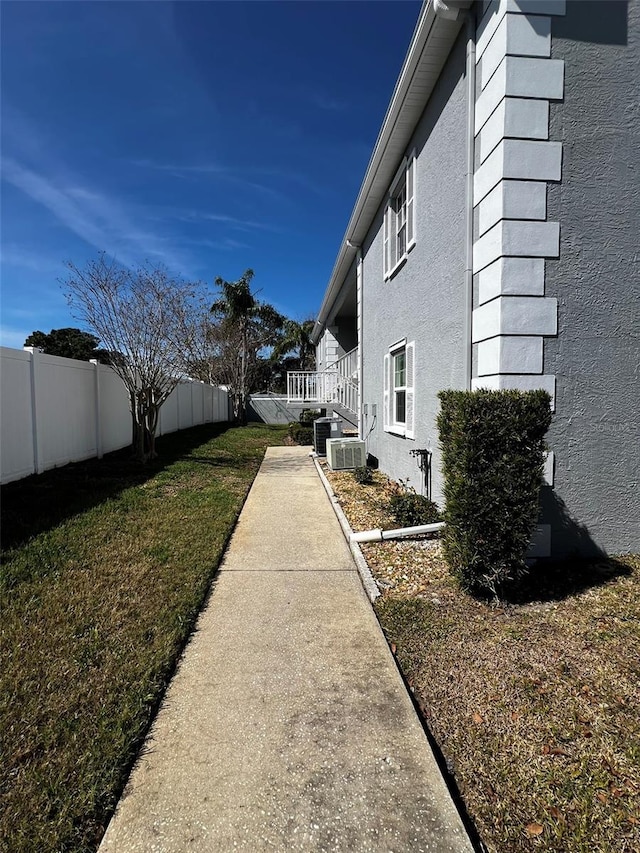 view of yard with fence and cooling unit