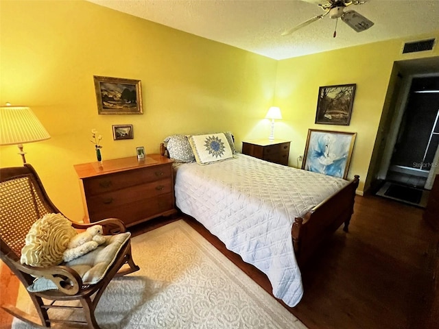 bedroom featuring visible vents, ceiling fan, and a textured ceiling