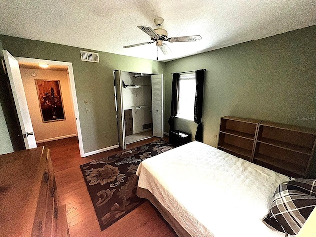 12027 Hoosier Ct Unit 104, Hudson, FL 34667 - bedroom featuring baseboards, visible vents, a closet, ceiling fan, and wood finished floors