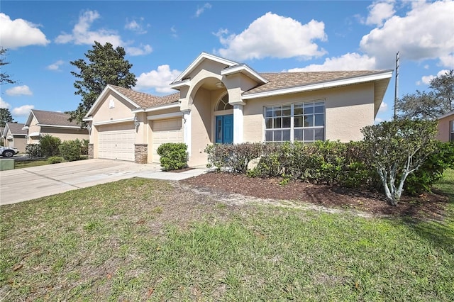 ranch-style home with a garage, concrete driveway, a front yard, and stucco siding