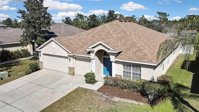 ranch-style home featuring driveway, an attached garage, roof with shingles, and stucco siding