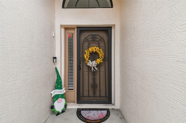 property entrance with stucco siding