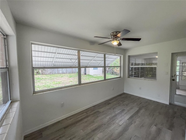 unfurnished sunroom featuring ceiling fan and a wealth of natural light