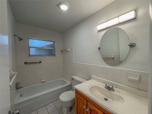 bathroom featuring tile walls, shower / bathing tub combination, toilet, vanity, and tile patterned floors