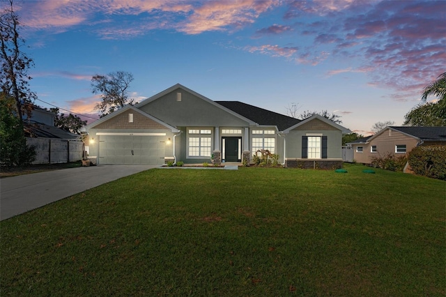 view of front of home with an attached garage, a front lawn, concrete driveway, and stucco siding