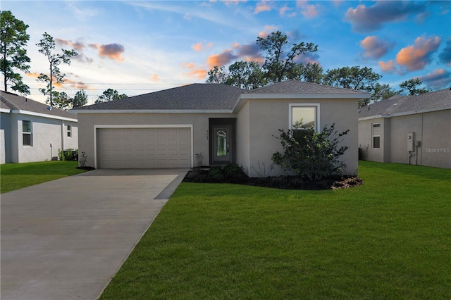 ranch-style house featuring a garage, driveway, roof with shingles, stucco siding, and a front yard