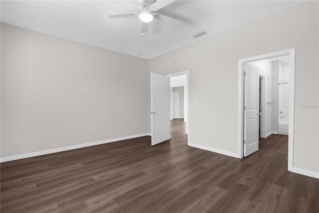 unfurnished bedroom featuring dark wood-type flooring, a ceiling fan, visible vents, and baseboards