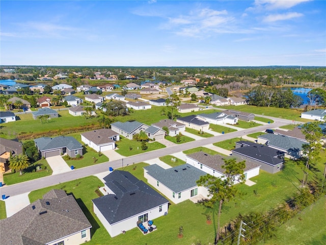 drone / aerial view with a residential view and a water view