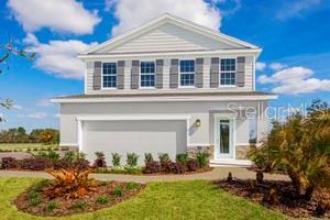 view of front of house featuring a garage and a front lawn