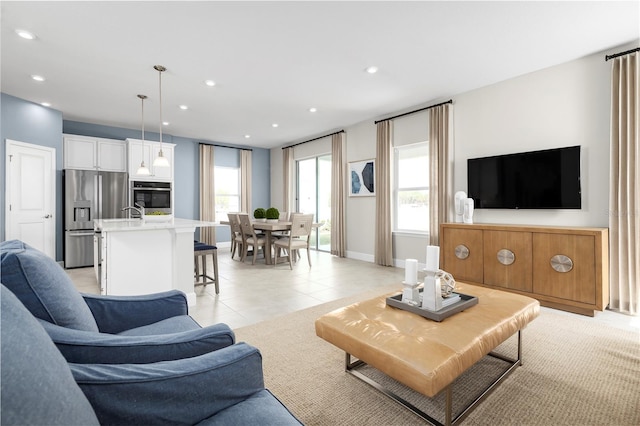 living area featuring light tile patterned floors, baseboards, and recessed lighting