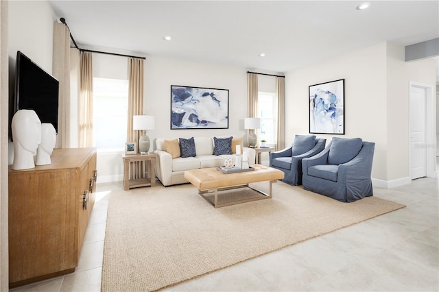 living room with baseboards and recessed lighting