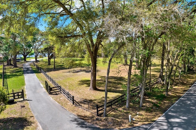 surrounding community with fence and driveway