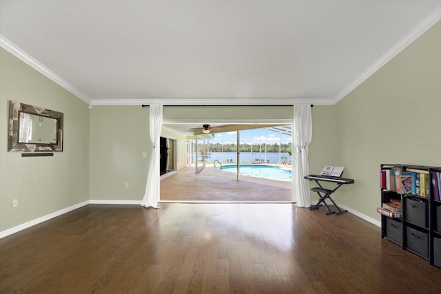 unfurnished room with ornamental molding, wood finished floors, baseboards, and a sunroom