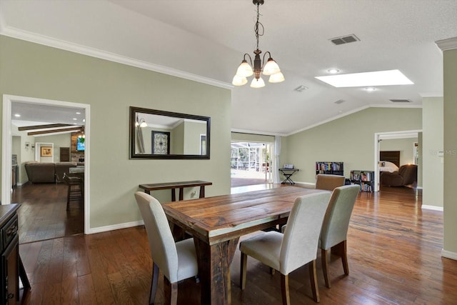 dining room with lofted ceiling with skylight, visible vents, dark wood finished floors, and crown molding