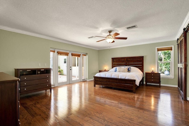 bedroom with access to exterior, wood finished floors, and visible vents