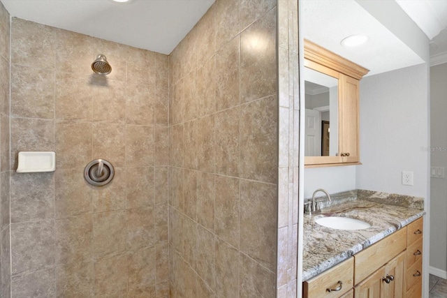 bathroom featuring vanity and tiled shower