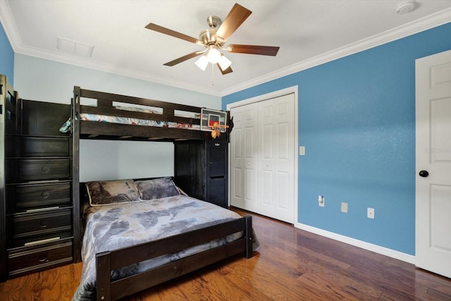 bedroom with ornamental molding, baseboards, and wood finished floors