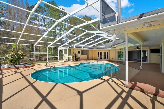 pool featuring a patio, french doors, and a lanai