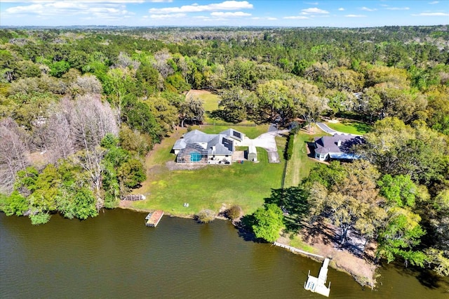 birds eye view of property featuring a wooded view and a water view