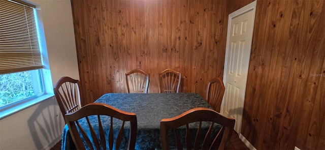 dining room with wood walls