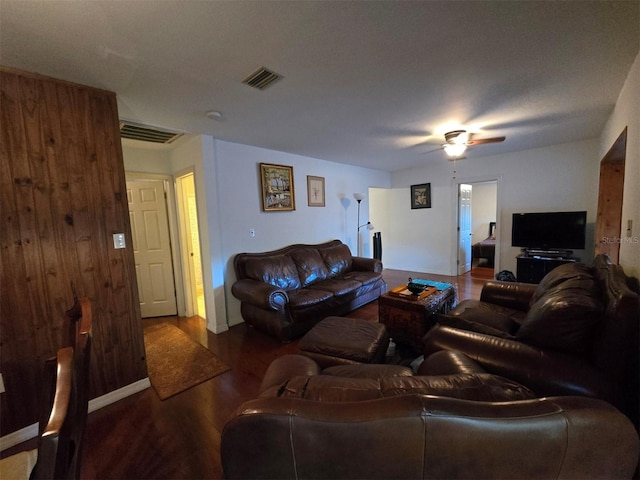 living room featuring baseboards, wood finished floors, visible vents, and ceiling fan