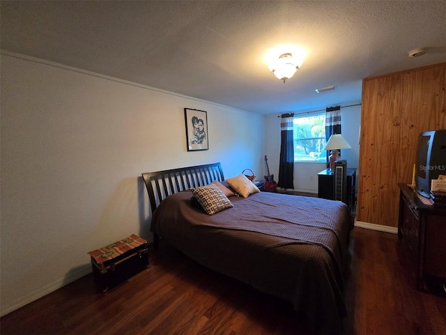 bedroom featuring a textured ceiling and wood finished floors