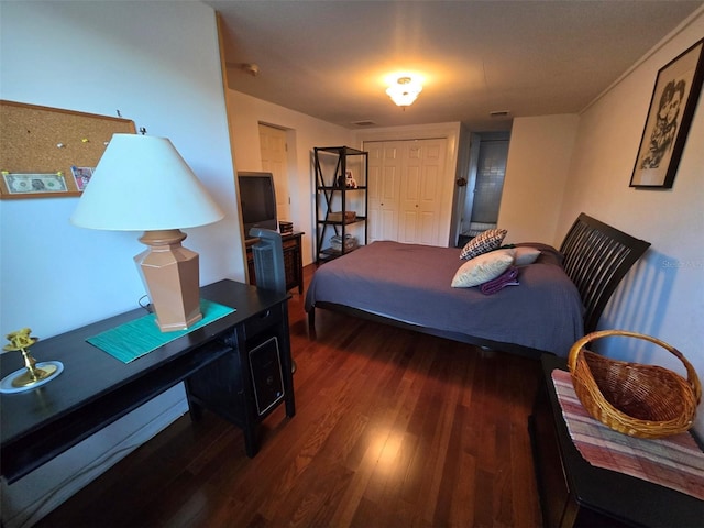 bedroom featuring visible vents and wood finished floors