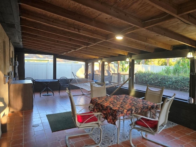 view of patio featuring outdoor dining area and fence