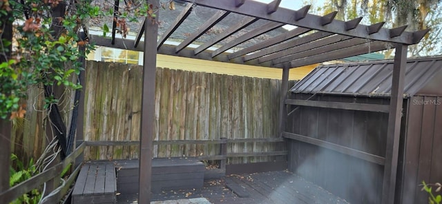 wooden deck with a pergola and fence